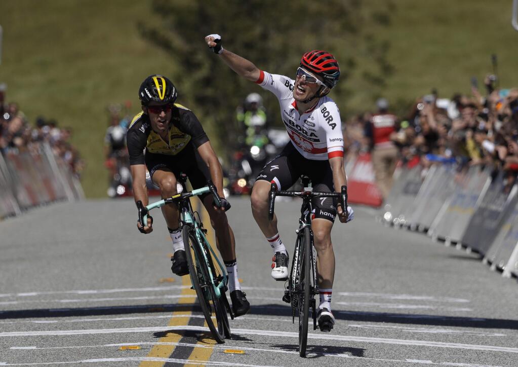 Rafal Majka, right, of Poland, celebrates as he defeats George Bennett, of New Zealand, to win Stage 2 of the Tour of California cycling race Monday, May 15, 2017, in San Jose , Calif. (AP Photo/Marcio Jose Sanchez)