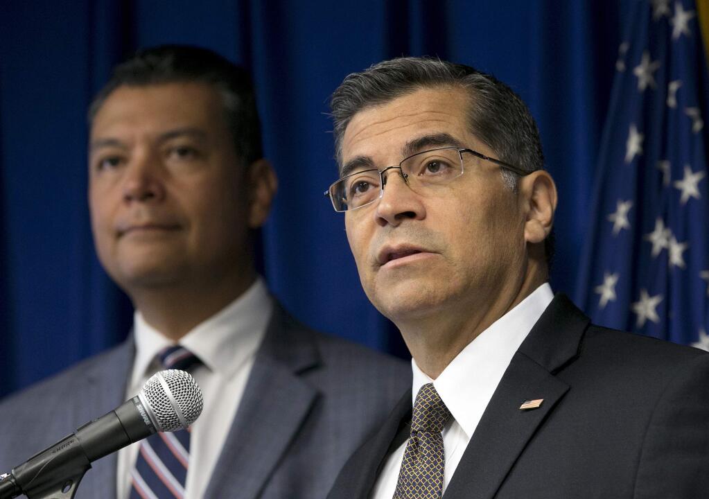 FILE - In this Sept. 5, 2017 file photo, California Attorney General Xavier Becerra, right, flanked by Secretary of State Alex Padilla, speaks to reporters at the Capitol in Sacramento. Becerra filed a lawsuit Monday, Sept. 11, against the Trump administration over its decision to end the Deferred Action for Childhood Arrivals program, or DACA, that protects young immigrants from deportation who were brought to the U.S. illegally as children or by parents who overstayed visas. (AP Photo/Rich Pedroncelli, File)