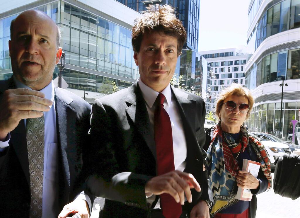 Agustin Huneeus, center, arrives at federal court Tuesday, May 21, 2019, in Boston, where he is scheduled to plead guilty to charges in a nationwide college admissions bribery scandal. (AP Photo/Michael Dwyer)