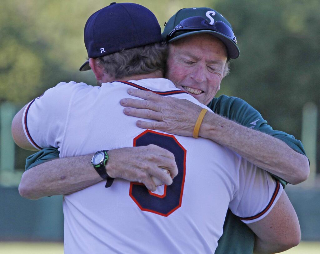 Bill Hoban/Index-TribuneLong-time coach honoredFormer Sonoma Valley High baseball coach Don Lyons hugs his son, Tommy, during ceremonies prior to the Sonoma Stompers game Wednesday. Lyons, who was the varsity coach for 18 years at SVHS before retiring after the season ended in May, was honored by the Stompers for his contributions to baseball in the Valley. He also received a framed jersey with his number, 9, signed by all of the Stompers.