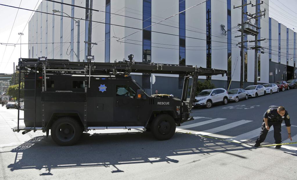 A San Francisco police armored vehicle arrives outside a UPS package delivery warehouse where a shooting took place Wednesday, June 14, 2017, in San Francisco. (AP Photo/Eric Risberg)