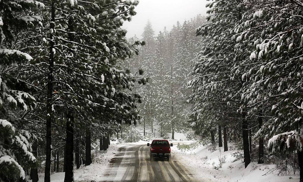 A snow covered Elk Mountain Road in the Mendocino National Forest above Upper Lake greets a driver during a low elevation snowfall event, Tuesday Jan. 3, 2017. (Kent Porter / The Press Democrat, 2017)