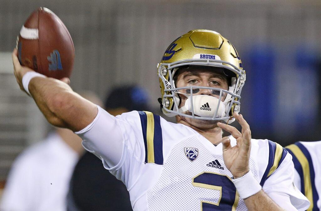 This Oct. 8, 2016 file photo shows UCLA quarterback Josh Rosen warming up prior to a game against Arizona State in Tempe, Ariz. (AP Photo/Ross D. Franklin)