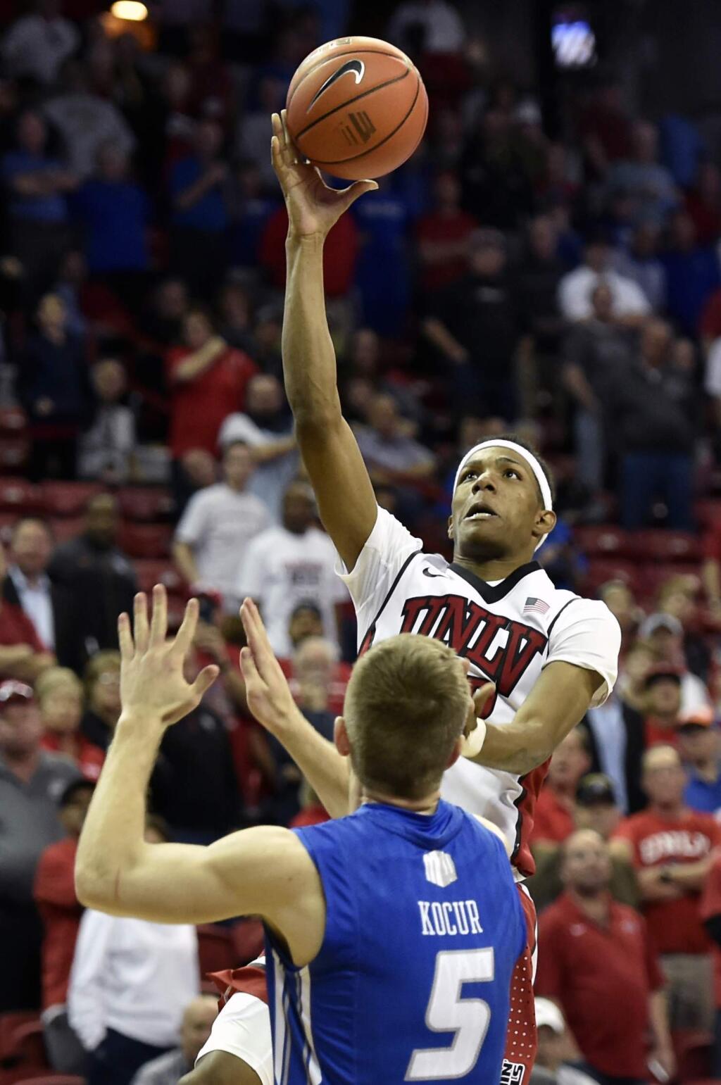 UNLV's Patrick McCaw (22) shoots over Air Force's Zach Kocur (5) during a game at the Mountain West Conference men's tournament Wednesday, March 9, 2016, in Las Vegas. UNLV won 108-102 in triple overtime. (AP Photo/David Becker)