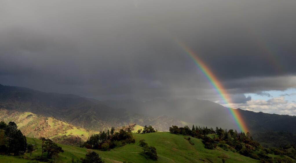 A rainbow forms at the foot of Mt. St. Helena, Tuesday, March 24, 2020 as thunderstorm rolls through. A frost advisory has been posted by the National Weather Service Thursday morning. (Kent Porter / The Press Democrat) 2020