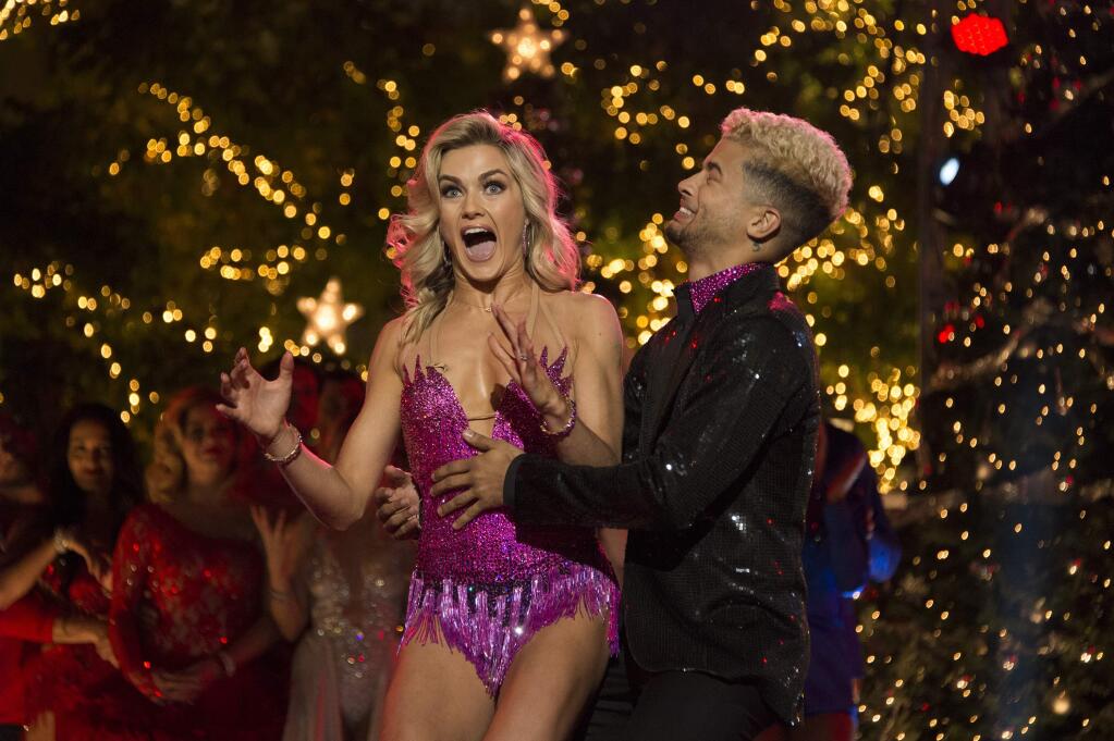 In this photo provided by ABC, Jordan Fisher, right, and Lindsay Arnold react after being named the champions of 'Dancing with the Stars' on Nov. 21, 2017, in Los Angeles. Fisher beat out violinist Lindsey Stirling and actor Frankie Muniz for the Mirrorball Trophy on the season 25 finale of the ABC reality competition. (Eric McCandless/ABC via AP)