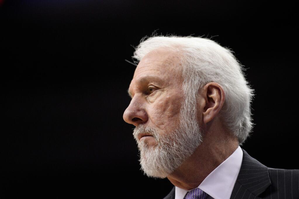 FILE - In this March 27, 2018, file photo, San Antonio Spurs head coach Gregg Popovich watches during the first half of an NBA basketball game against the Washington Wizards, in Washington. The wife of Spurs coach Gregg Popovich has died. She was 67. The Spurs confirmed Erin Popovich's death Wednesday, April 18, 2018. The team didn't provide further details. (AP Photo/Nick Wass, File)