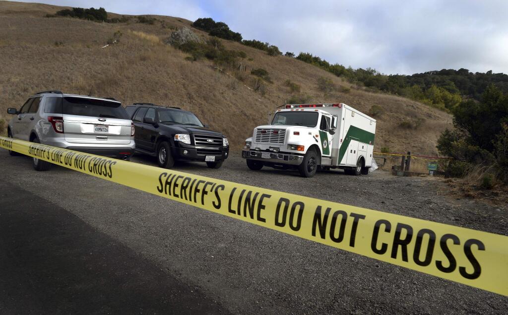 In this Tuesday, Oct. 6, 2015 photo, Marin County Sheriff's Office personnel investigate a homicide near the top of White's Hill on Old Railroad Grade near Fairfax, Calif. (Robert Tong/Marin Independent Journal via AP)