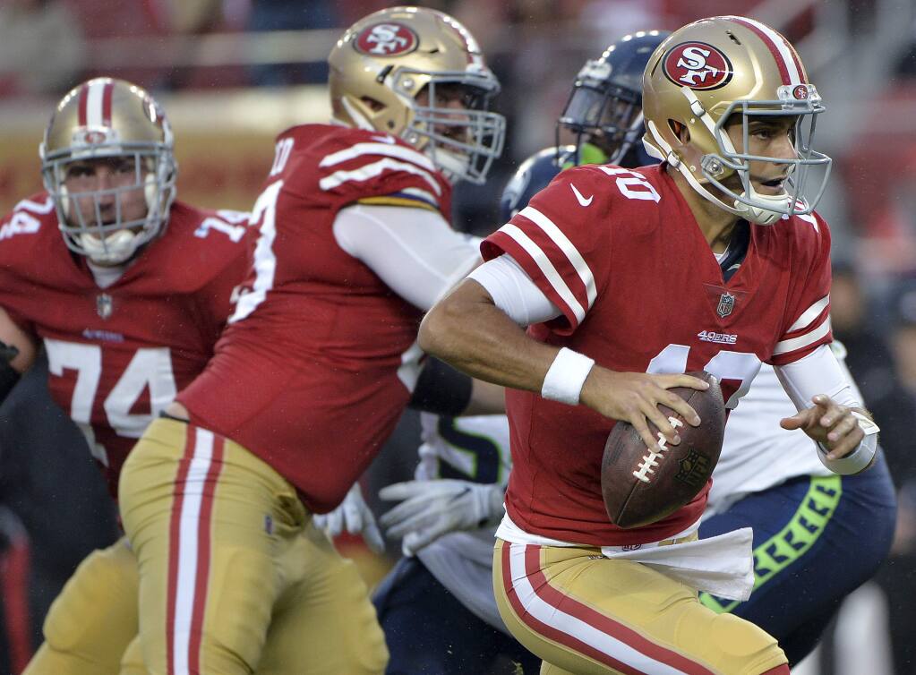 San Francisco 49ers quarterback Jimmy Garoppolo runs against the Seattle Seahawks during the second half on Sunday, Nov. 26, 2017, in Santa Clara. (AP Photo/Don Feria)