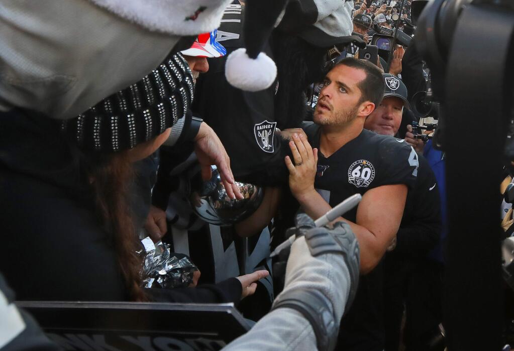 Oakland Raiders quarterback Derek Carr meets with fans in the Black Hole following his team's loss to the Jacksonville Jaguars in Oakland on Sunday, December 15, 2019. The Jaguars defeated the Raiders 20-16.(Christopher Chung/ The Press Democrat)