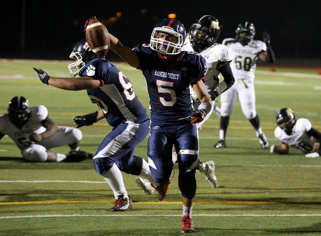 Rancho Cotate's Mo Ward takes the ball into the end zone for a touchdown during the first half of the game held at Rancho Cotate High School, Friday, September 19, 2014. (Crista Jeremiason / The Press Democrat)