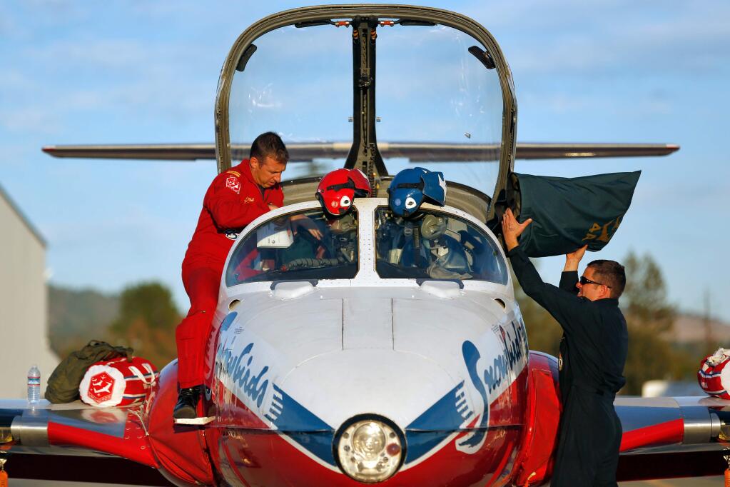 Snowbird 4 Captain Phillipe Roy, left, and Aviation Technician Master Corporal Russel Egler, members of the Canadian Forces Snowbirds air demonstration squadron unload their aircraft as they arrive at Sonoma County Airport in Santa Rosa, California on Thursday, September 24, 2015. (Alvin Jornada / The Press Democrat)