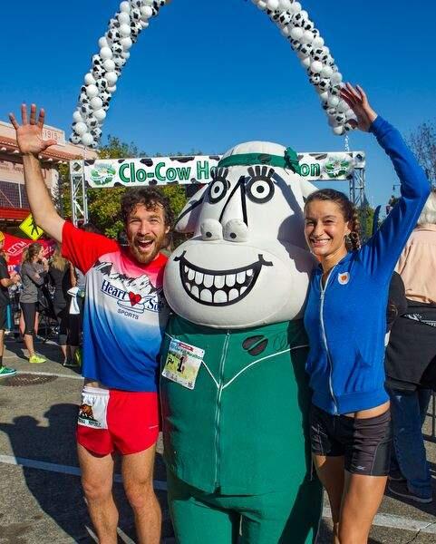 Clo Cow Half Marathan winners Alex Wolf-Root of Santa Rosa and Sarah Hallas of Cotati pose with Clo following the downtown Petaluma event on Sept. 18, 2016. (JOHN O'HARA/ FOR THE ARGUS-COURIER)