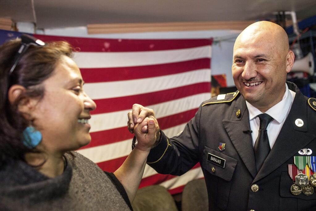 Hector Barajas-Varela, a deported U.S. Army veteran, right, celebrates with Norma Chavez-Peterson, executive director of the ACLU of San Diego and Imperial counties, after Barajas-Varela was delivered an announcement granting his American citizenship in Tijuana, Mexico, Thursday, March 29, 2018. Barajas came to the United States from Mexico when he was 7 years old and, after graduating high school, served in the U.S. Army from 1995 to 2001, when he was honorably discharged, according to a federal lawsuit filed in December seeking citizenship. He was a member of the 82nd Airborne Division and received several military accolades. (AP Photo/Joel Angel Juarez)