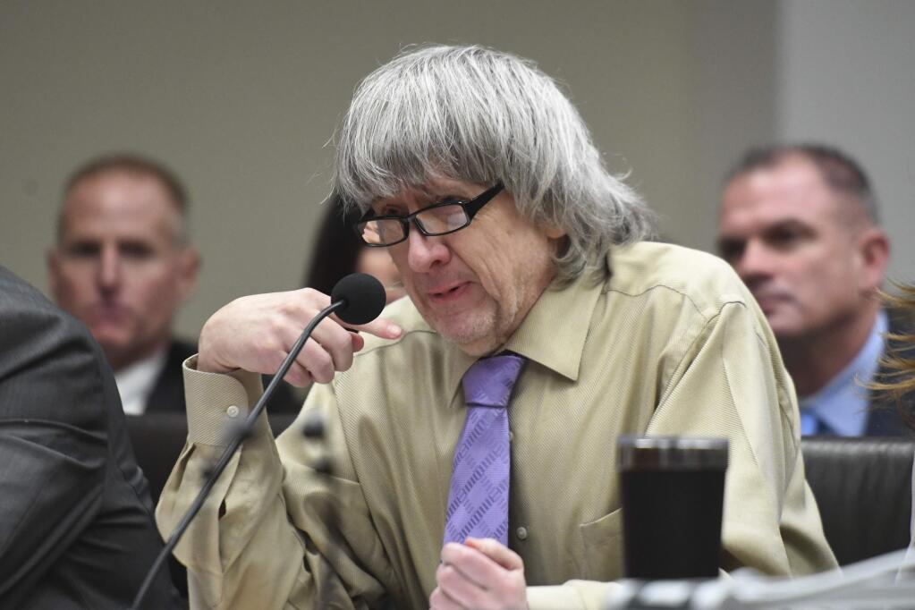 David Turpin becomes emotional as he reads a statement during a sentencing hearing Friday, April 19, 2019, in Riverside, Calif. Turpin and his wife, Louise, who pleaded guilty to years of torture and abuse of 12 of their 13 children have been sentenced to life in prison with possibility of parole after 25 years. (Will Lester/The Orange County Register via AP, Pool)
