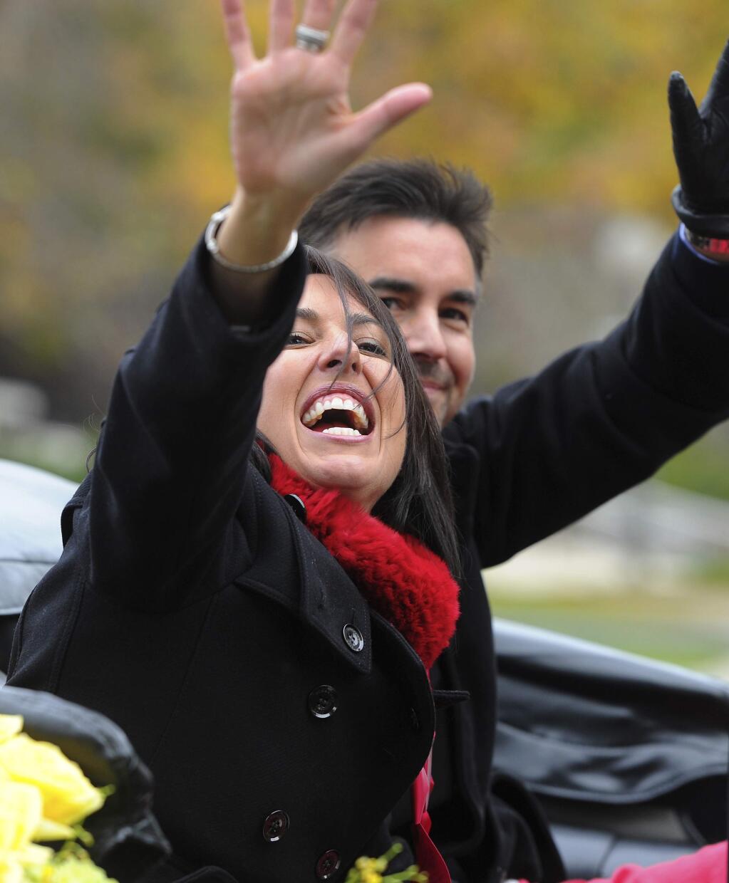 Grand Marshal Olympian Janet Evans, left, waves to the crowd at the 128th Rose Parade in Pasadena, Calif., Monday, Jan. 2, 2017. (AP Photo/Michael Owen Baker)
