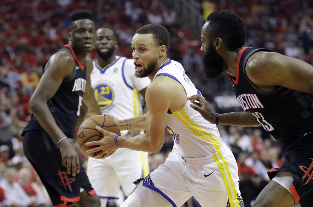 Golden State Warriors guard Stephen Curry, center, drives around Houston Rockets guard James Harden, right, during the first half in Game 2 of the NBA Western Conference Ffinal, Wednesday, May 16, 2018, in Houston. (AP Photo/David J. Phillip)