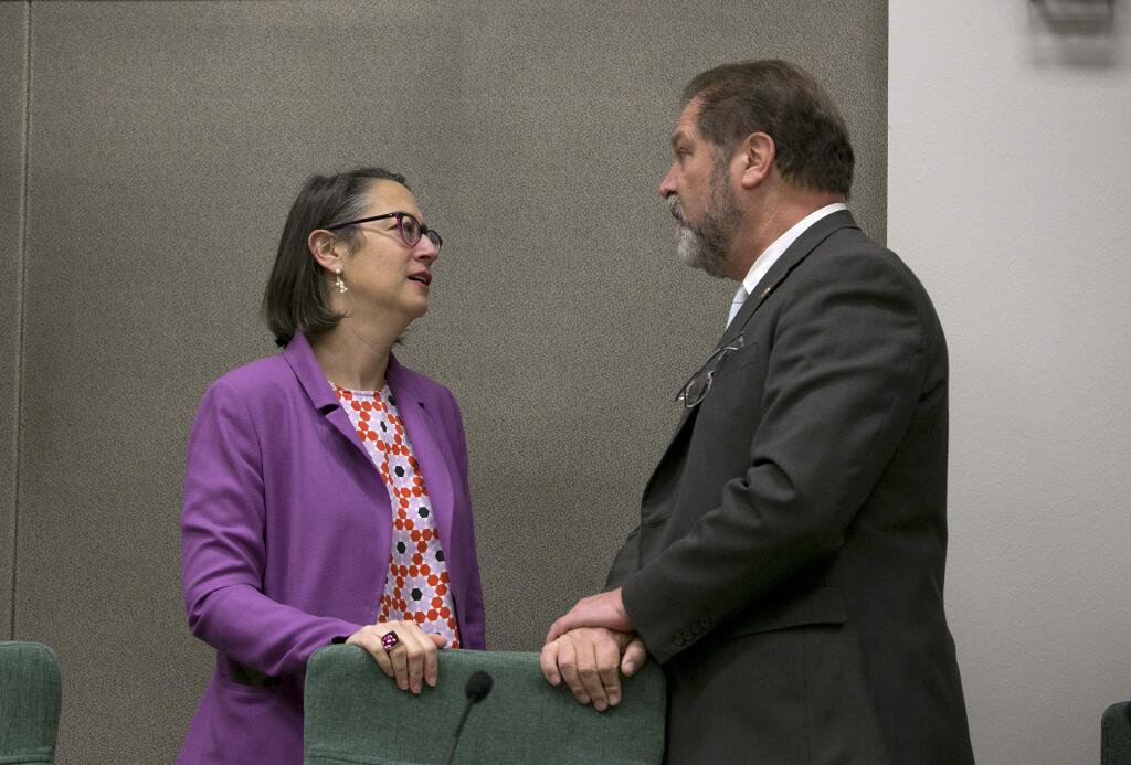 Assemblywoman Laura Friedman, D-Glendale, left, chairwoman of a joint legislative committee on sexual harassment prevention and response, talks with committee member state Sen. John Moorlach, R-Costa Mesa, before the committee hearing Wednesday, Jan. 24, 2018, in Sacramento, Calif. Lawmakers from both houses joined together to start the process to reform the Legislature's policies for handling sexual harassment allegations. (AP Photo/Rich Pedroncelli)