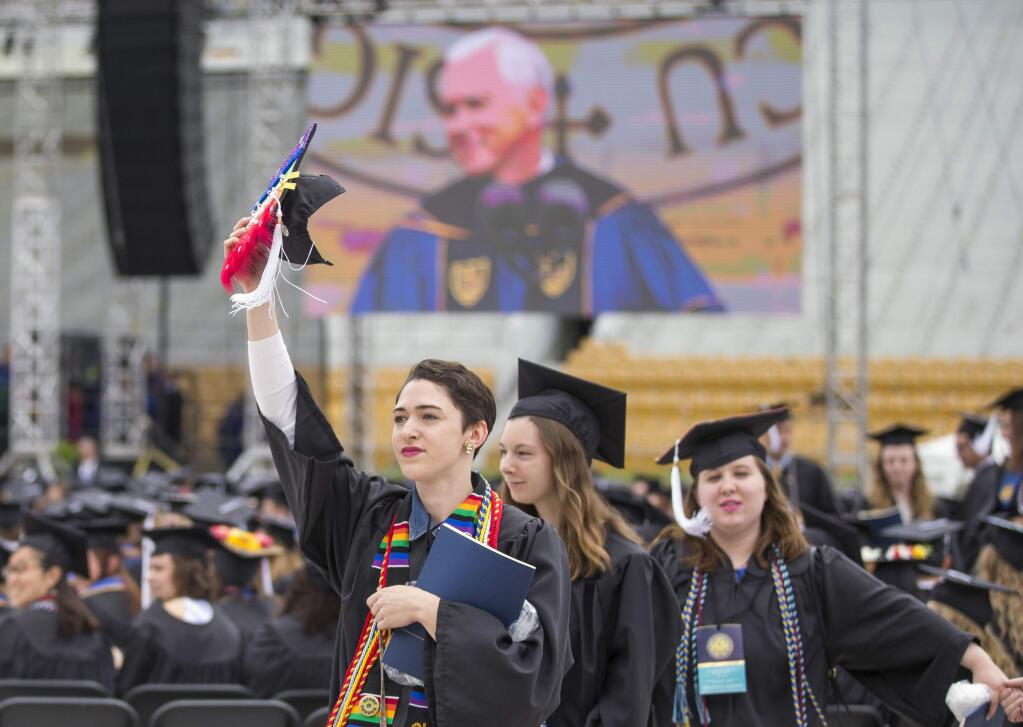 Notre Dame graduates walk out of Notre Dame Stadium in protest as Vice President Mike Pence speaks during the 2017 commencement ceremony. (ROBERT FRANKLIN / South Bend, Indiana Tribune)
