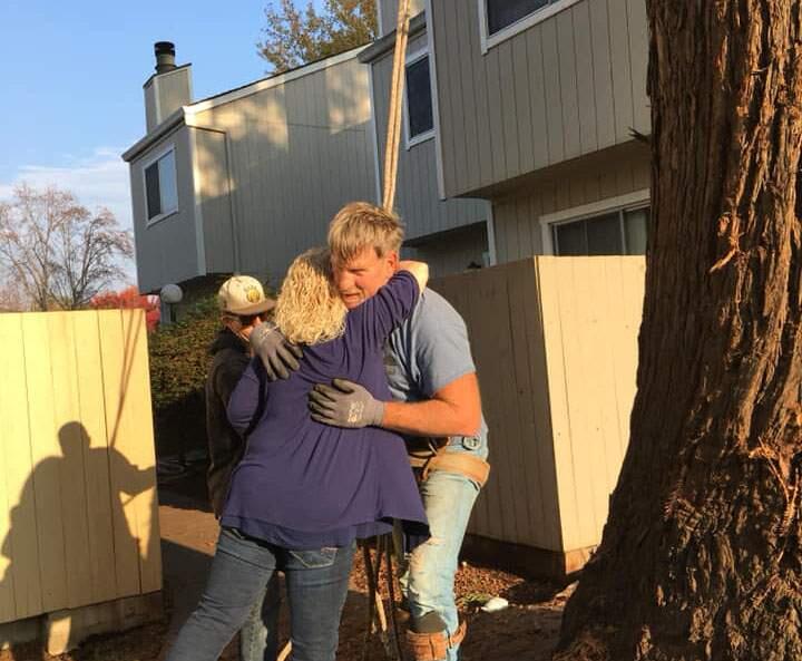 Paul Derkos of Sebastopol hugs a resident after he saved a cat from a tree in Rohnert Park on Monday. (Kate Weber-Linhart)