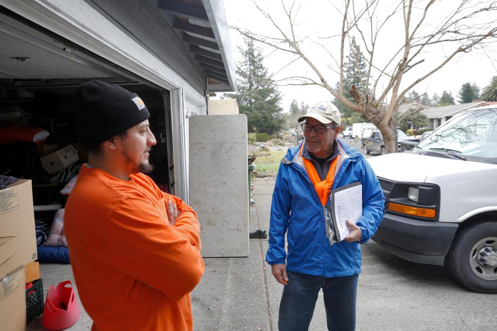 Former Santa Rosa mayor Chris Coursey, right, talks with resident Louis Garcia in front of his home as Coursey canvasses voters during his campaign for Sonoma County District 3 supervisor, challenging incumbent Shirlee Zane, in Rohnert Park, California, on Saturday, January 25, 2020. (Alvin Jornada / The Press Democrat)