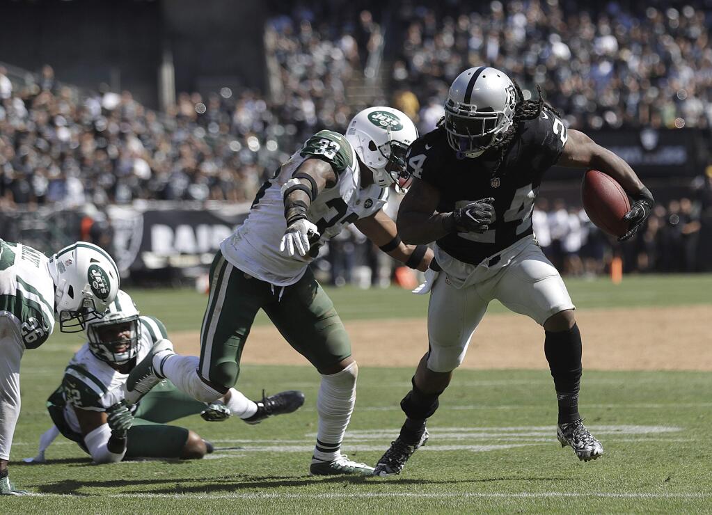 Oakland Raiders running back Marshawn Lynch, right, runs against the New York Jets during the first half in Oakland on Sunday, Sept. 17, 2017. (AP Photo/Marcio Jose Sanchez)