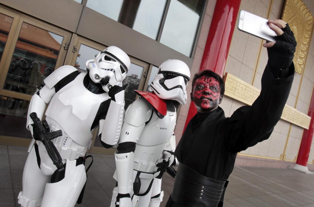 Fans dressed as movie Star Wars characters and take photos to cerebrate on the Star Wars Day in Taipei, Taiwan, Wednesday, May 4, 2016. (AP Photo/Chiang Ying-ying)