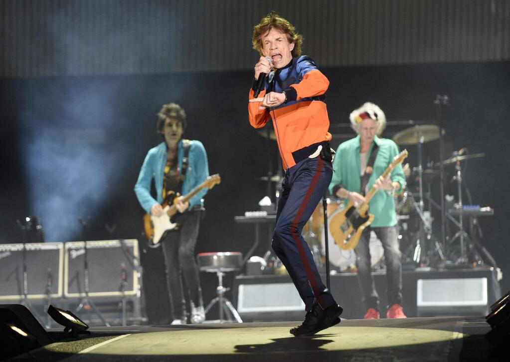 FILE - In this Oct. 7, 2016 file photo, Mick Jagger, center, performs with Ron Wood, left, and Keith Richards of the Rolling Stones during their performance on day 1 of the 2016 Desert Trip music festival at Empire Polo Field in Indio, Calif. Jagger, the 73-year-old frontman of the Rolling Stones, was on hand Thursday, Dec. 8, 2016 at a New York hospital when girlfriend, Melanie Hamrick, gave birth to the couple's son. According to a statement, both parents are “delighted” and “mother and baby are doing well.”(Photo by Chris Pizzello/Invision/AP)