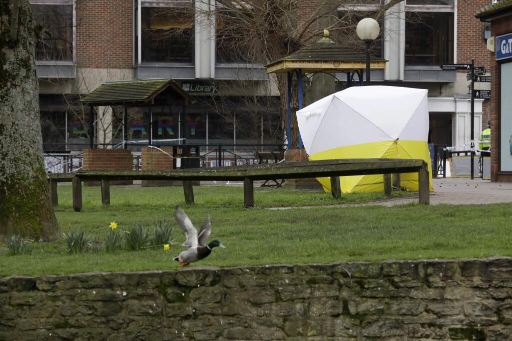 A police tent covers the area where former Russian double agent Sergei Skripal and his daughter were found critically ill following exposure to the Russian-developed nerve agent Novichok in Salisbury, England, Tuesday, March 13, 2018. (AP Photo/Matt Dunham)