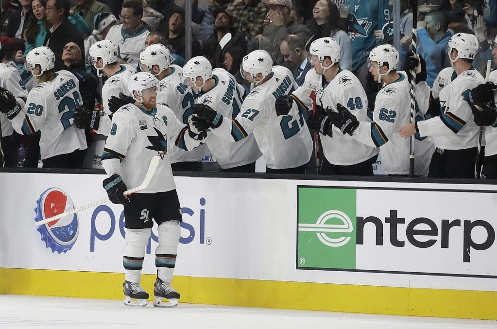 San Jose Sharks center Joe Pavelski (8) is congratulated by teammates after scoring against the Carolina Hurricanes during the second period in San Jose, Wednesday, Dec. 5, 2018. (AP Photo/Jeff Chiu)