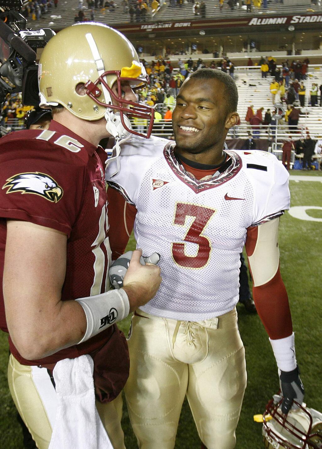 FILE - In this Nov. 3, 2007, file photo, Boston College quarterback Matt Ryan, left, congratulates Florida State's Myron Rolle after FSU defeated Boston College 27-17 in an NCAA college football game at Alumni Stadium in Boston. Rolle was an All-American defensive back at Florida State but his bigger accomplishments have come off the field. He was a Rhodes Scholar and last month graduated from Florida State's College of Medicine. Rolle begins his neurosurgery residency next month at Harvard Medical School. (AP Photo/Tallahassee Democrat, Mike Ewen, File)/Tallahassee Democrat via AP)