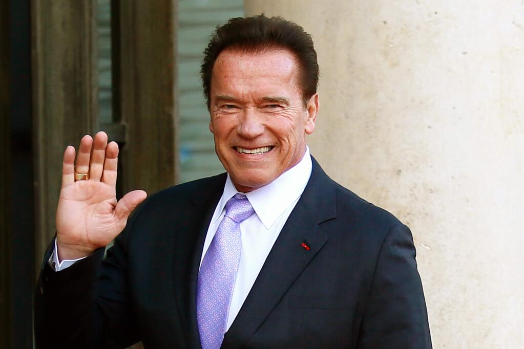 FILE - In this Dec. 12, 2017 file photo, Arnold Schwarzenegger waves as he arrives at the Elysee Palace prior to a meeting on climate change in Paris. (AP Photo/Francois Mori, File)