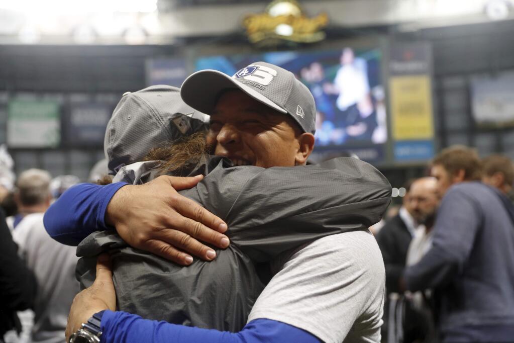 Los Angeles Dodgers manager Dave Roberts celebrates after Game 7 of the National League Championship Series baseball game Saturday, Oct. 20, 2018, in Milwaukee. The Dodgers won 5-1 to advance to the World Series. (AP Photo/Jeff Roberson)