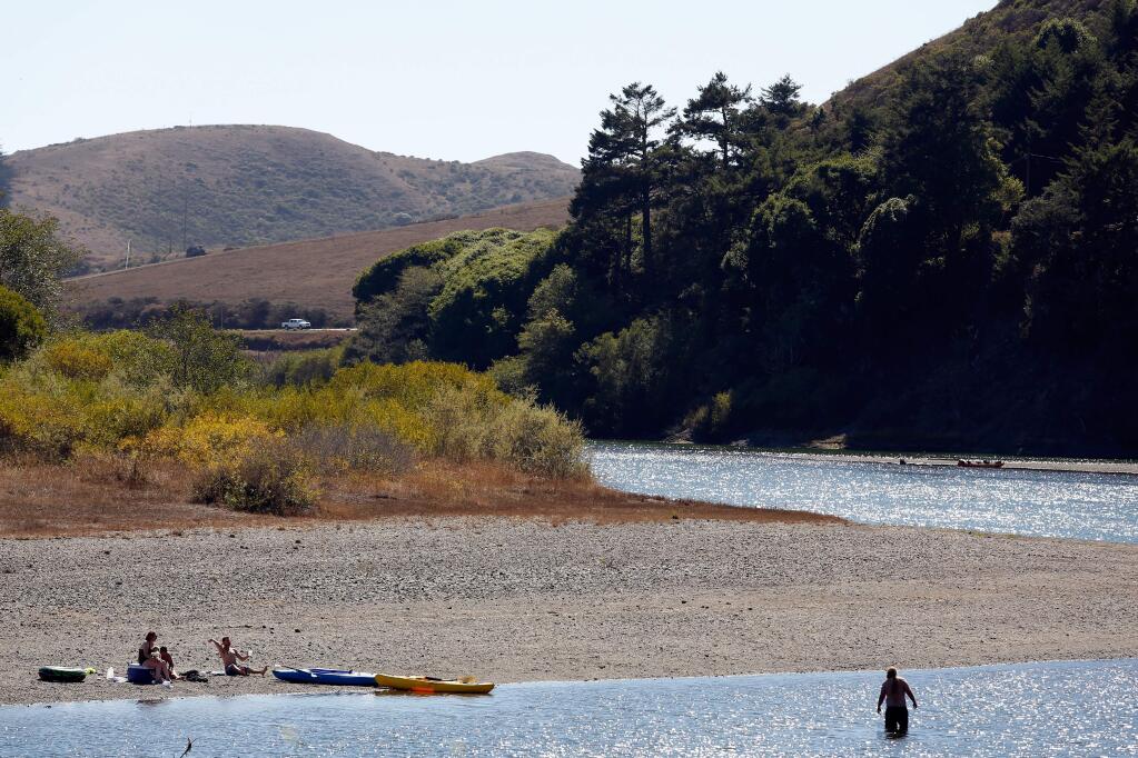 Kayakers rest at a quiet spot on the Russian River near Jenner on Sunday, Sept. 6, 2015. (Alvin Jornada / The Press Democrat)