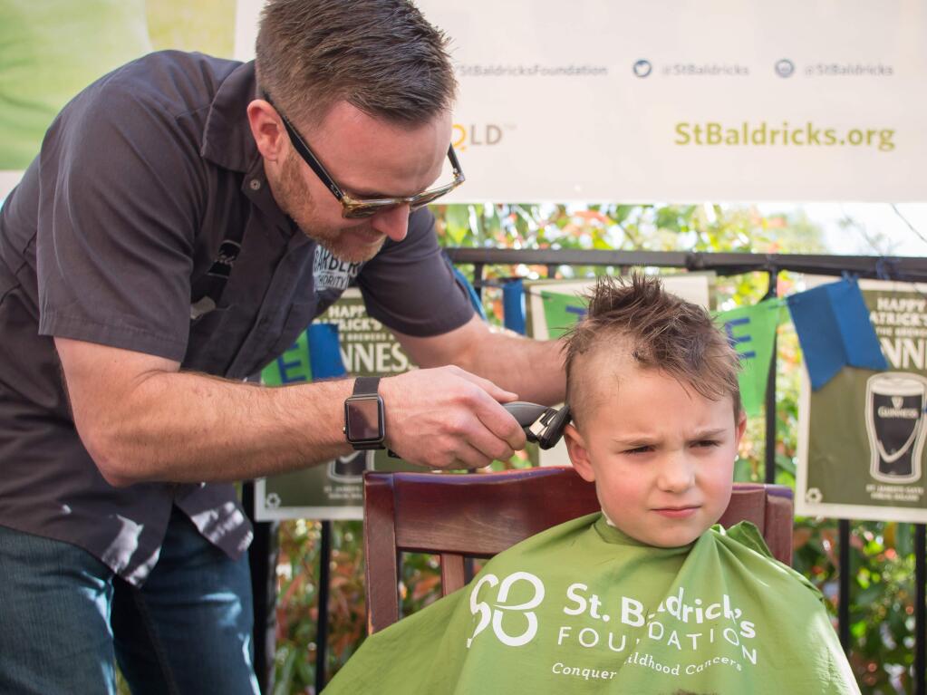 Chris Lands shaves heads during a St. Baldrick's fundraiser event at Patterson's Pub in Windsor on Saturday, March 25, 2017. St. Baldrick's raises money to help fight childhood cancer. (JEREMY PORTJE/ FOR THE PD)