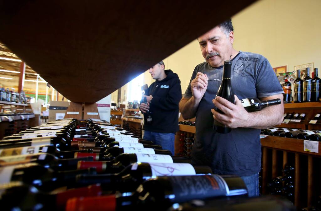 Pablo Corina, right, shops for wine with his son, Christopher, at Bottle Barn in Santa Rosa on Wednesday, January 28, 2015. (Christopher Chung/ The Press Democrat)