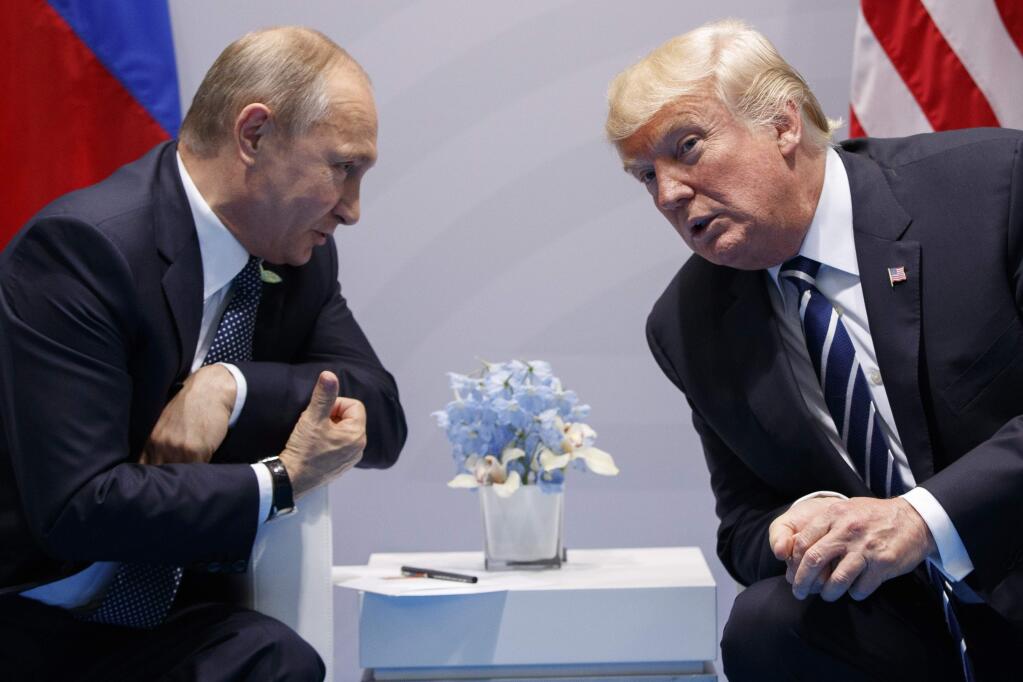 FILE - In this file photo taken on Friday, July 7, 2017, U.S. President Donald Trump meets with Russian President Vladimir Putin at the G-20 Summit in Hamburg, Germany. Vladimir Putin looks more invincible than ever before in his 18 years in power, after Russians invaded Ukraine, blanket-bombed Syria and hacked the U.S. election campaign. (AP Photo/Evan Vucci)