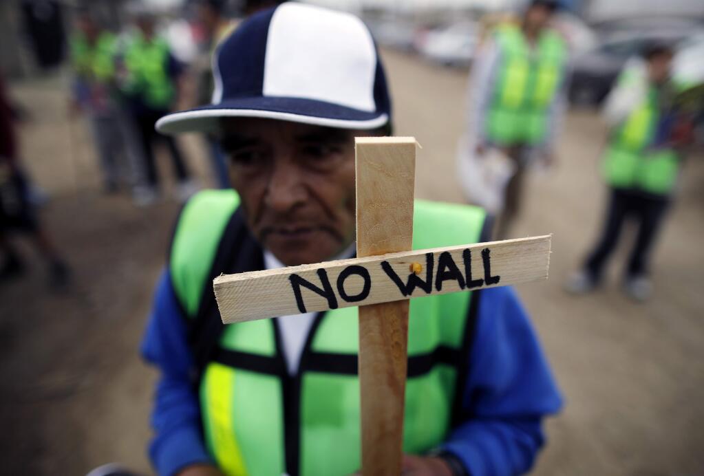 Roberto Perez Garcia of Mexico participates in a rally against the border wall on Tuesday in Tijuana, Mexico before President Donald Trump's arrival to inspect prototypes for the wall. (GREGORY BULL / Associated Press)