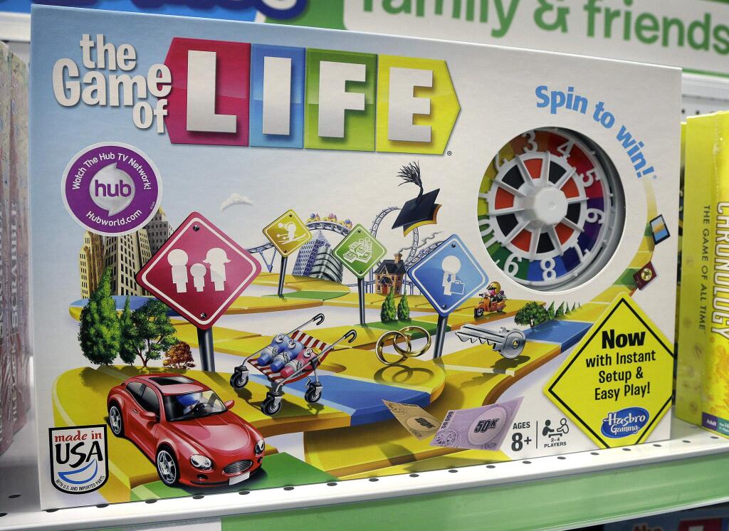 FILE - In this Nov. 11, 2015 file photo, the Hasbro board game 'The Game of Life' rests on a shelf in a toy store in North Attleboro, Mass. A trial begins Thursday, Nov. 16, 2017, in federal court in Los Angeles over who invented the game and who owns the rights to it. (AP Photo/Steven Senne, File)
