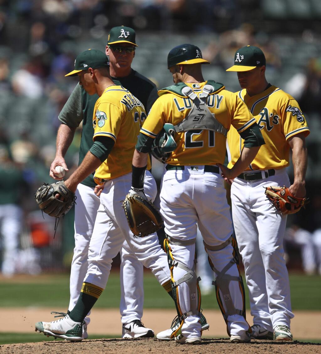 Oakland Athletics pitcher Daniel Mengden, left, is relieved by manager Bob Melvin, second from left, during the seventh inning against the Houston Astros, Wednesday, May 9, 2018, in Oakland. (AP Photo/Ben Margot)