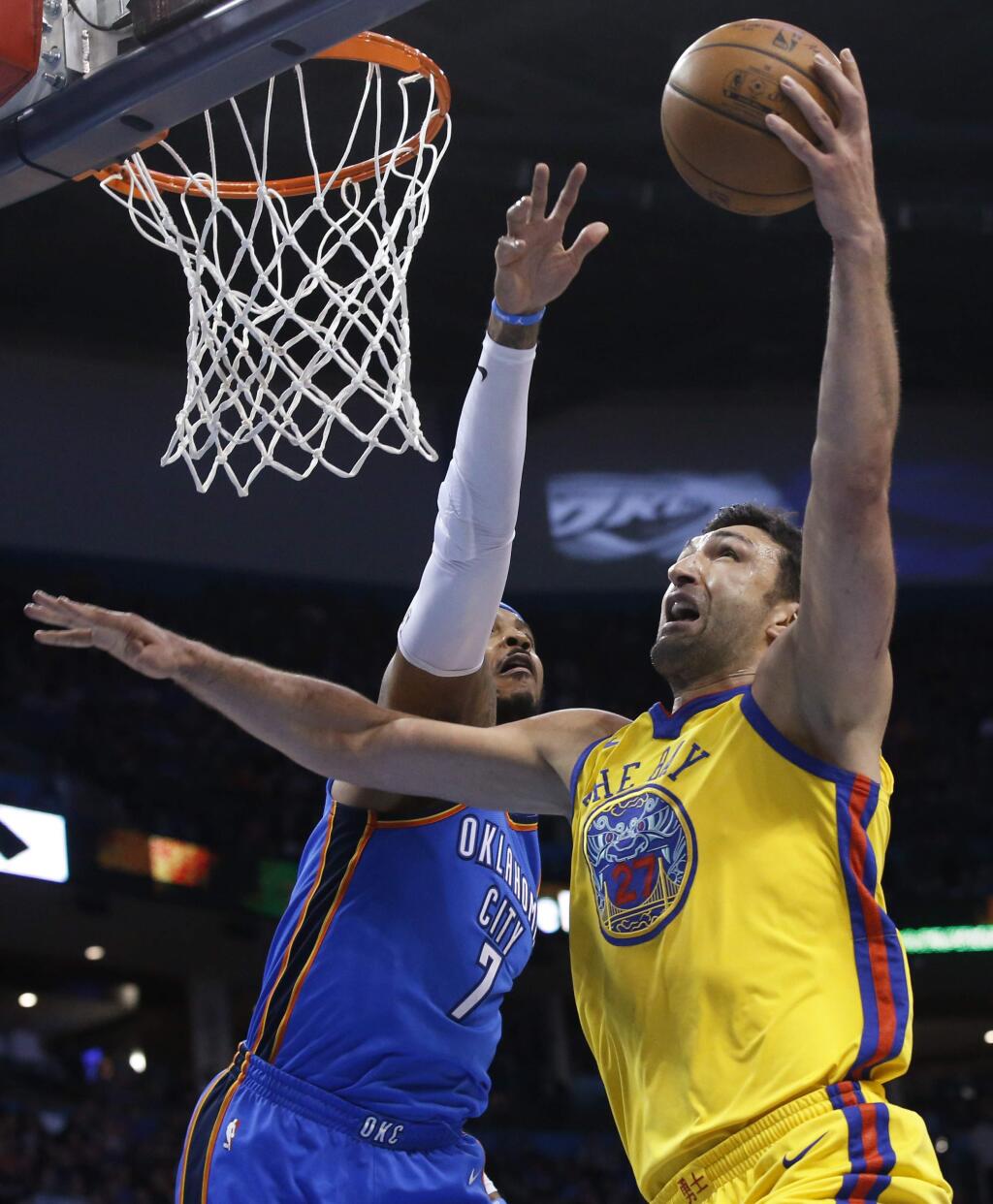 Golden State Warriors center Zaza Pachulia, right, shoots in front of Oklahoma City Thunder forward Carmelo Anthony during the first half in Oklahoma City, Tuesday, April 3, 2018. (AP Photo/Sue Ogrocki)