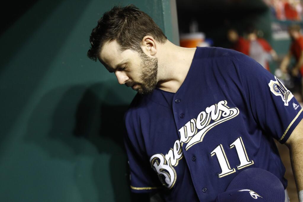 Milwaukee Brewers' Mike Moustakas walks out of the dugout after a National League wild-card baseball game against the Washington Nationals, Tuesday, Oct. 1, 2019, in Washington. Washington won 4-3. (AP Photo/Patrick Semansky)