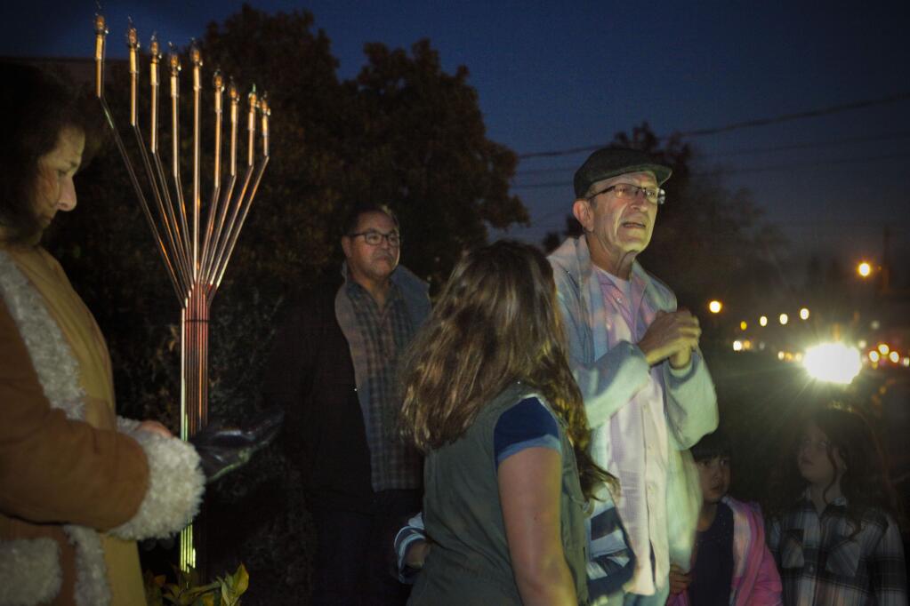 Petaluma, CA, USA. Tuesday, December 12, 2017._ On the first night of Chanukkah, B'nai Israel unveiled their first outdoor menorah. Rabbi Ted Feldman led the gathering with song and a blessing. (CRISSY PASCUAL/ARGUS-COURIER STAFF)
