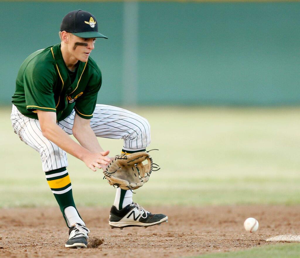 Casa Grande's Joe Lampe, left, scoops up a grounder to make the throw to first base for an out in the top of the seventh inning of the NCS Division II semifinal baseball game between Ukiah and Casa Grande high schools in Petaluma, California, on Wednesday, May 31, 2017. (Alvin Jornada / The Press Democrat)