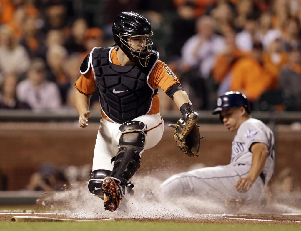 The San Diego Padres' Will Venable, right, scores behind San Francisco Giants catcher Andrew Susac in the first inning of a baseball game Friday, Sept. 26, 2014, in San Francisco. Venable scored on a single by Padres' Yasmani Grandal. (AP Photo/Ben Margot)