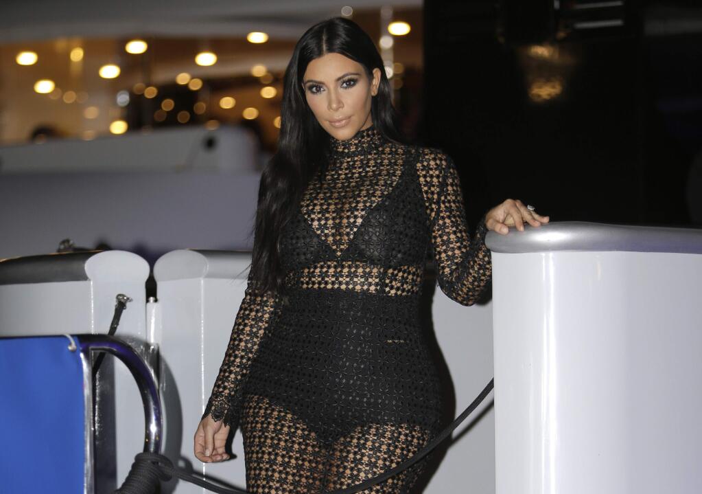 In this June 24, 2015 photo, American television and social media personality,socialite, and model Kim Kardashian poses during a photocall at the Cannes Lions 2015, International Advertising Festival in Cannes, southern France. The reality TV star is scheduled to speak and sign copies of her new coffee table book Selfish during a Tuesday, June 30 night event hosted by the Commonwealth Club of California, which bills itself as the nation's oldest and largest public affairs forum.(AP Photo/Lionel Cironneau)