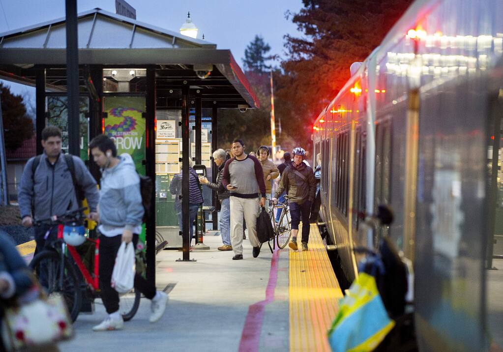 SMART riders exit the train at the Railroad Square station in Santa Rosa. SMART refuses to release its daily and weekly ridership numbers despite repeated records requests. (photo by John Burgess/The Press Democrat)