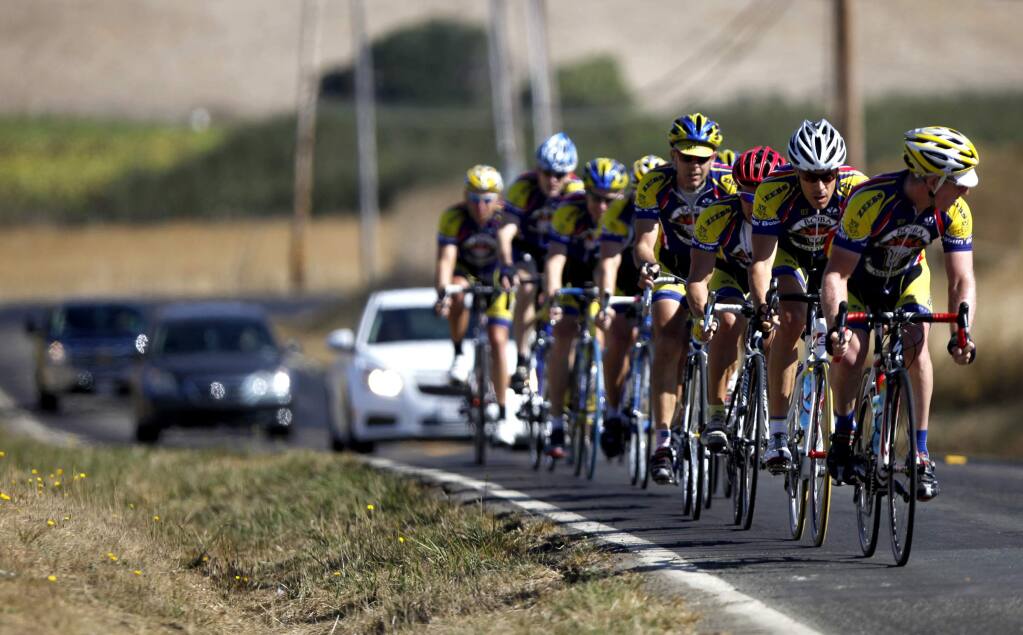 Cyclists and cars share the lane on Point Reyes-Petaluma Road west of Petaluma in 2011. (BETH SCHLANKER/ PD FILE)