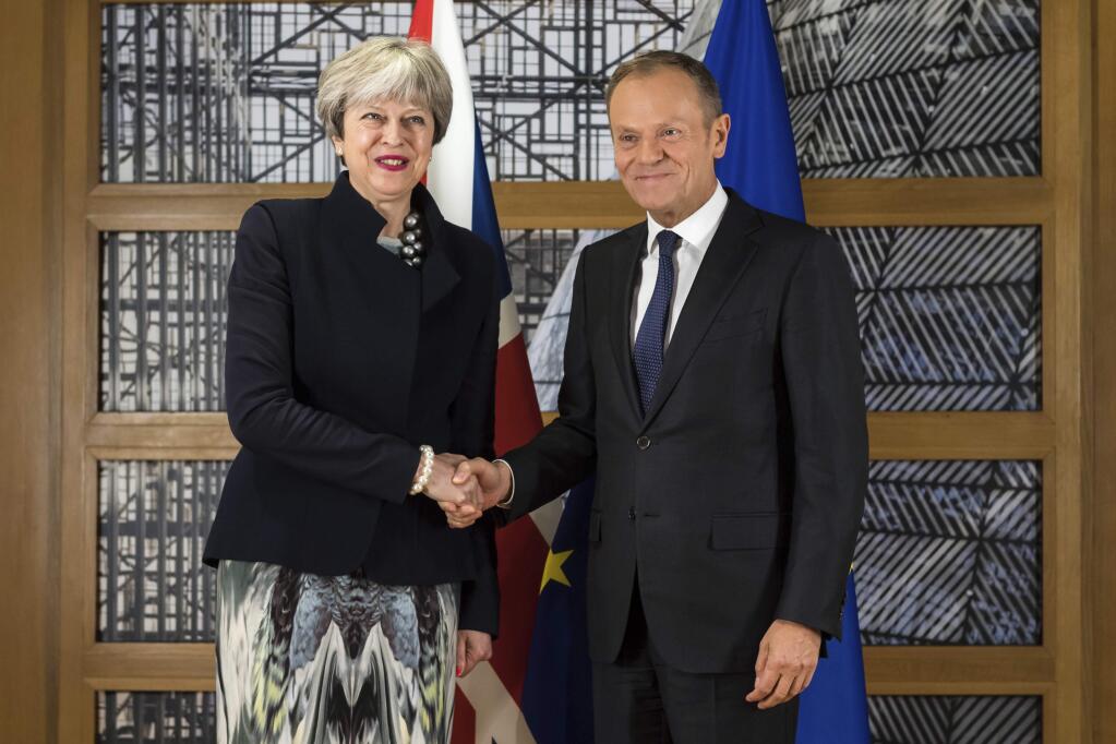 British Prime Minister Theresa May, left, shakes hands with European Council President Donald Tusk at the Europa building in Brussels on Monday, Dec. 4, 2017. British Prime Minister Theresa May and EU Commission President Jean-Claude Juncker held a power lunch on Monday before meeting European Council President Donald Tusk, seeking a breakthrough in the Brexit negotiations ahead of a key EU summit the week after. (AP Photo/Geert Vanden Wijngaert)