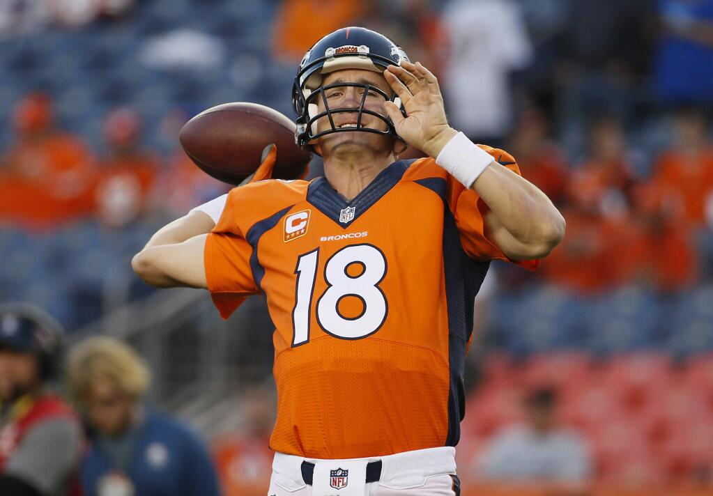 Denver Broncos quarterback Peyton Manning warms up prior to the Broncos' NFL football game against the San Diego Chargers, Thursday, Oct. 23, 2014, in Denver. (AP Photo/Jack Dempsey)